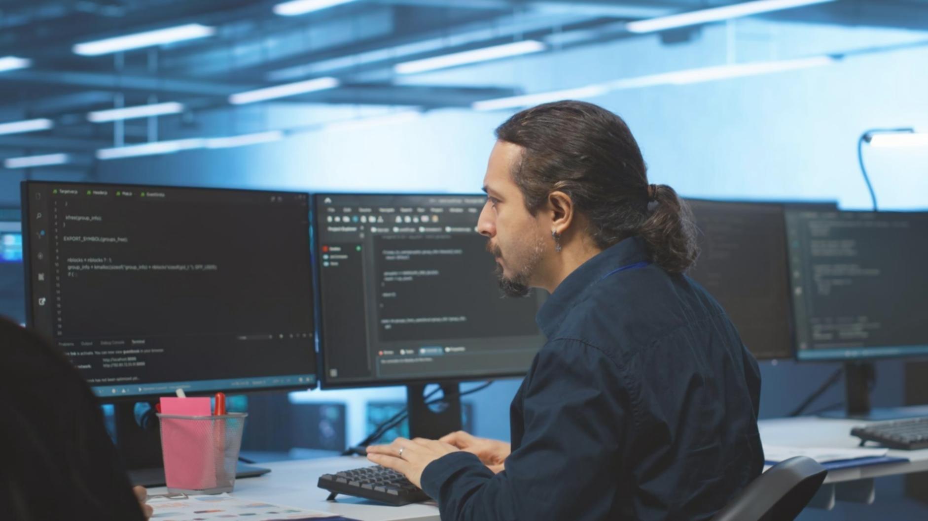 Software testing professional reviewing application interface on multiple devices